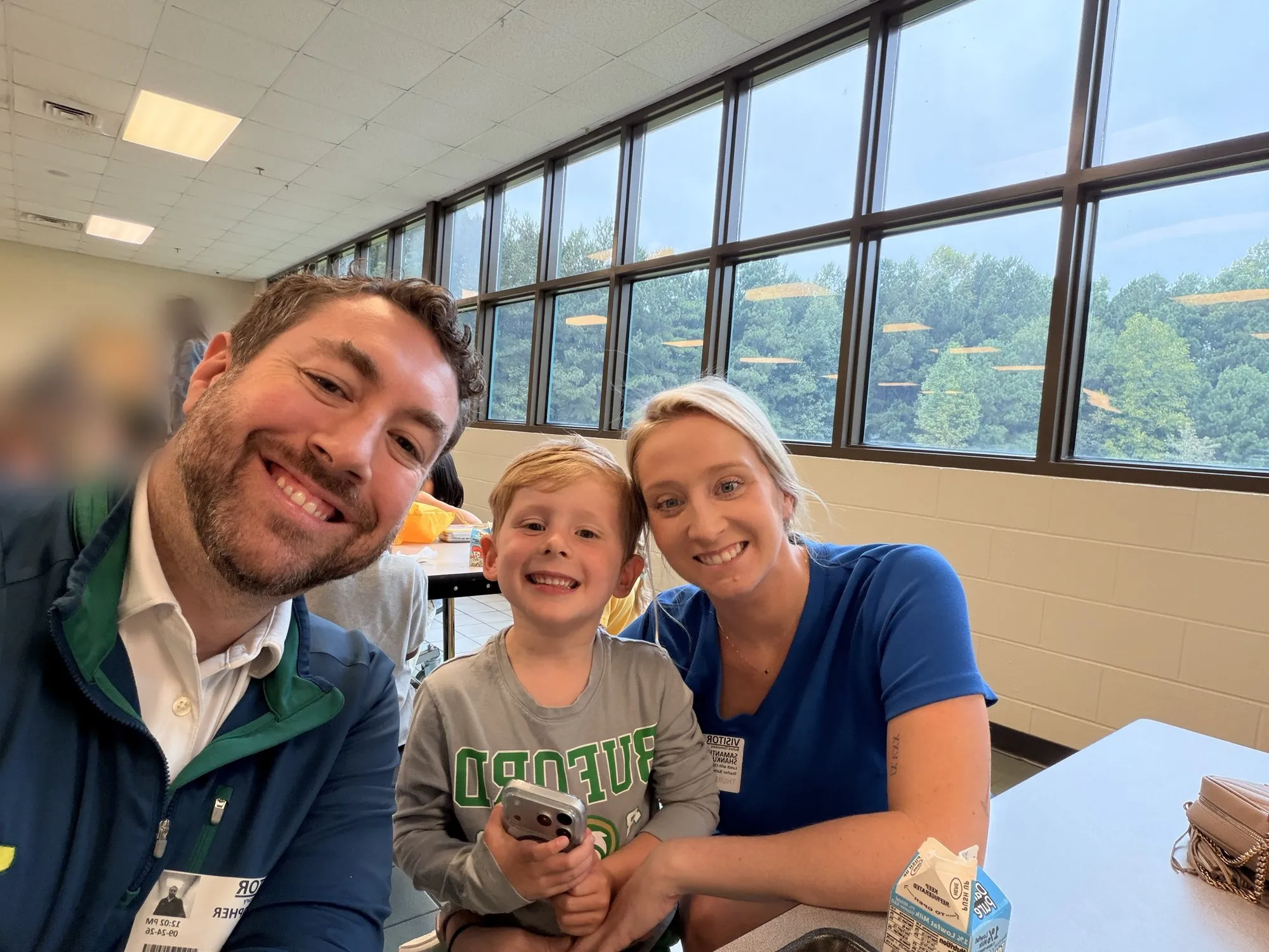 Chris, Samantha, and their son at school lunch